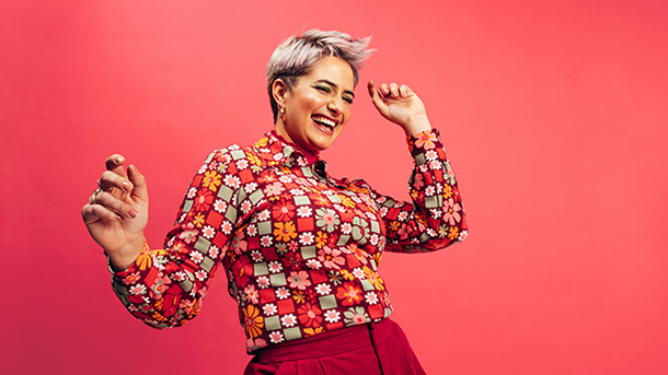 Dancing, smiling woman on red background